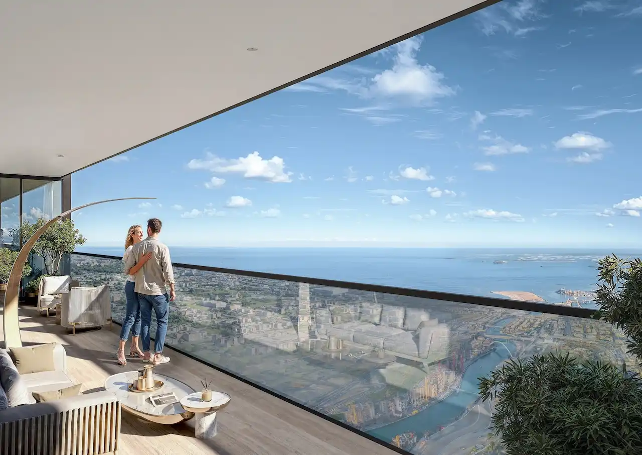 Couple enjoying panoramic sea and city views from a private balcony at Sobha SkyParks on Sheikh Zayed Road presented by Tohid Fetrat.
