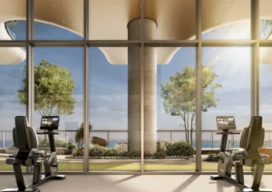 Sobha SkyParks gym featuring modern fitness equipment, floor to ceiling glass, landscaped terrace views, and a calm luxury wellness environment in Dubai presented by Tohid Fetrat.