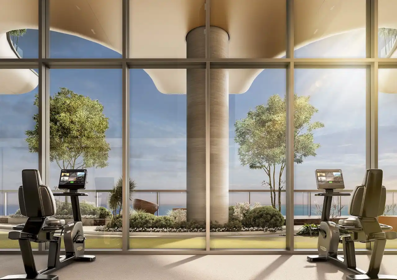 Sobha SkyParks gym featuring modern fitness equipment, floor to ceiling glass, landscaped terrace views, and a calm luxury wellness environment in Dubai presented by Tohid Fetrat.