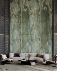 Sobha SkyParks lobby interior featuring natural green stone wall, refined seating area, and luxury residential design in Dubai prepared by Tohid Fetrat.