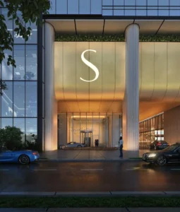 Main entrance and drop off area of Sobha SkyParks on Sheikh Zayed Road featuring a grand architectural facade and illuminated arrival experience presented by Tohid Fetrat.