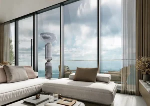 Sea view living lounge at Sobha SkyParks featuring floor to ceiling windows, modern seating, and calm coastal ambiance in Dubai presented by Tohid Fetrat.