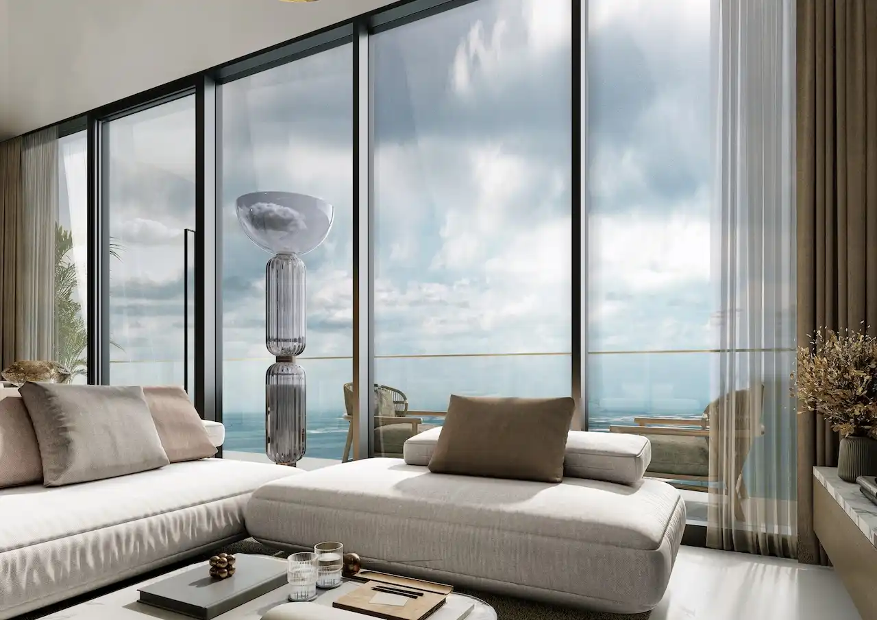 Sea view living lounge at Sobha SkyParks featuring floor to ceiling windows, modern seating, and calm coastal ambiance in Dubai presented by Tohid Fetrat.