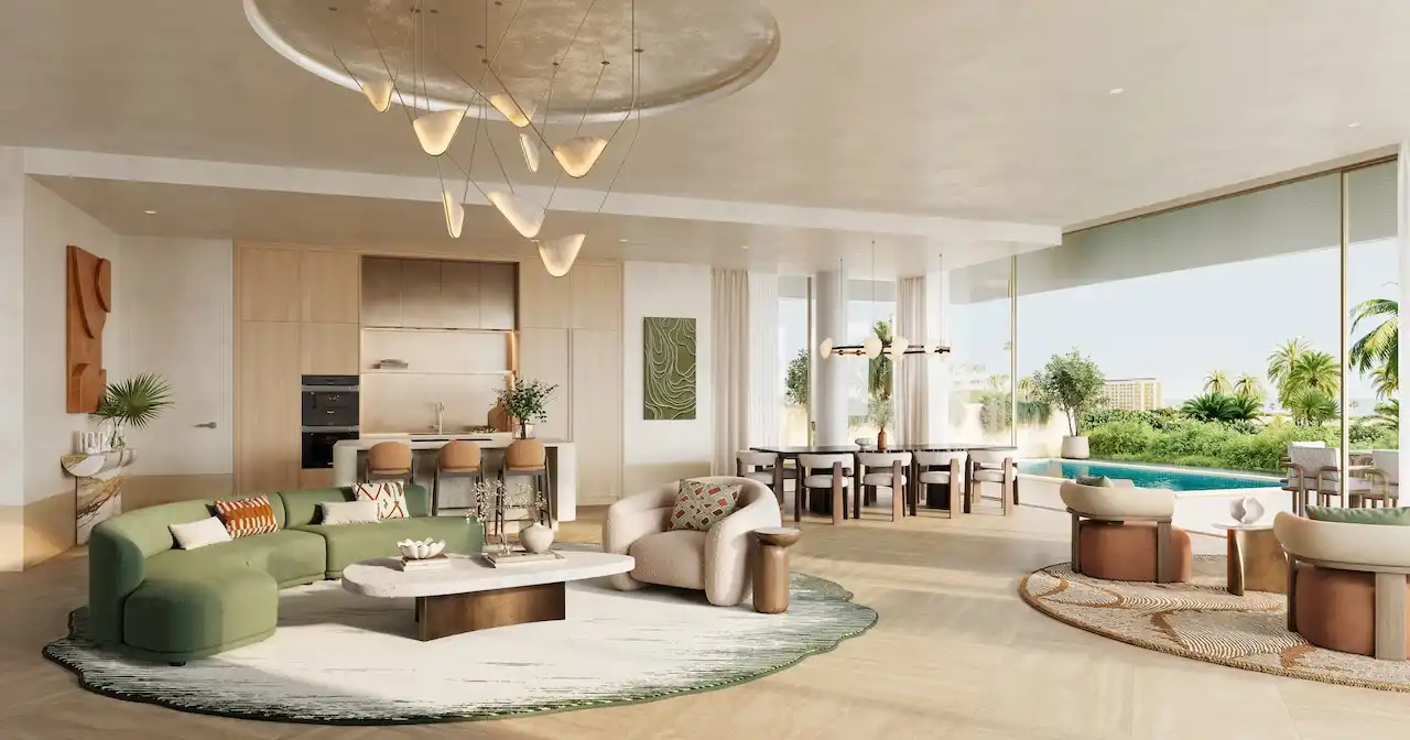 Garden living room of a 3 bedroom residence at Solaya by Meraas in Dubai, featuring open plan interiors, modern kitchen and dining area, floor to ceiling windows and direct access to a private garden. Presented by Tohid Fetrat.