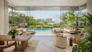 Private garden and pool area of a 3 bedroom residence at Solaya by Meraas in Dubai, featuring floor to ceiling glass, outdoor lounge seating, landscaped greenery and seamless indoor outdoor living. Presented by Tohid Fetrat.