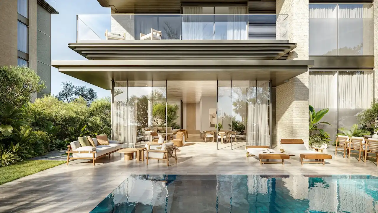 Garden terrace of a 3 bedroom residence at Solaya by Meraas in Dubai, featuring a private outdoor seating area, floor to ceiling glass, lush landscaping and seamless indoor outdoor living beside a serene water feature. Presented by Tohid Fetrat.