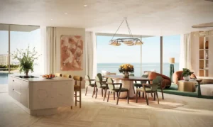 Luxury 4 bedroom apartment kitchen and dining area at Solaya by Meraas in Dubai, featuring an open plan layout, stone kitchen island, elegant dining space, floor to ceiling windows and panoramic waterfront views. Presented by Tohid Fetrat.