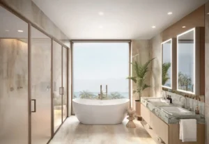 Luxury master bathroom of a 4 bedroom apartment at Solaya by Meraas in Dubai, featuring a freestanding bathtub, premium marble finishes, double vanity, floor to ceiling glass and serene waterfront views. Presented by Tohid Fetrat.