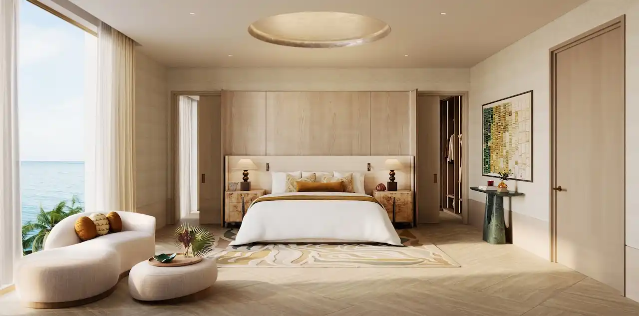Luxury master bedroom of a 4 bedroom apartment at Solaya by Meraas in Dubai, featuring refined interiors, soft neutral tones, floor to ceiling windows, private seating area and tranquil waterfront views. Presented by Tohid Fetrat.