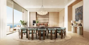 Kitchen and dining area of a 5 bedroom apartment at Solaya by Meraas in Dubai, featuring a spacious dining table, open plan kitchen, floor to ceiling windows, Gulf views and refined contemporary finishes. Presented by Tohid Fetrat.