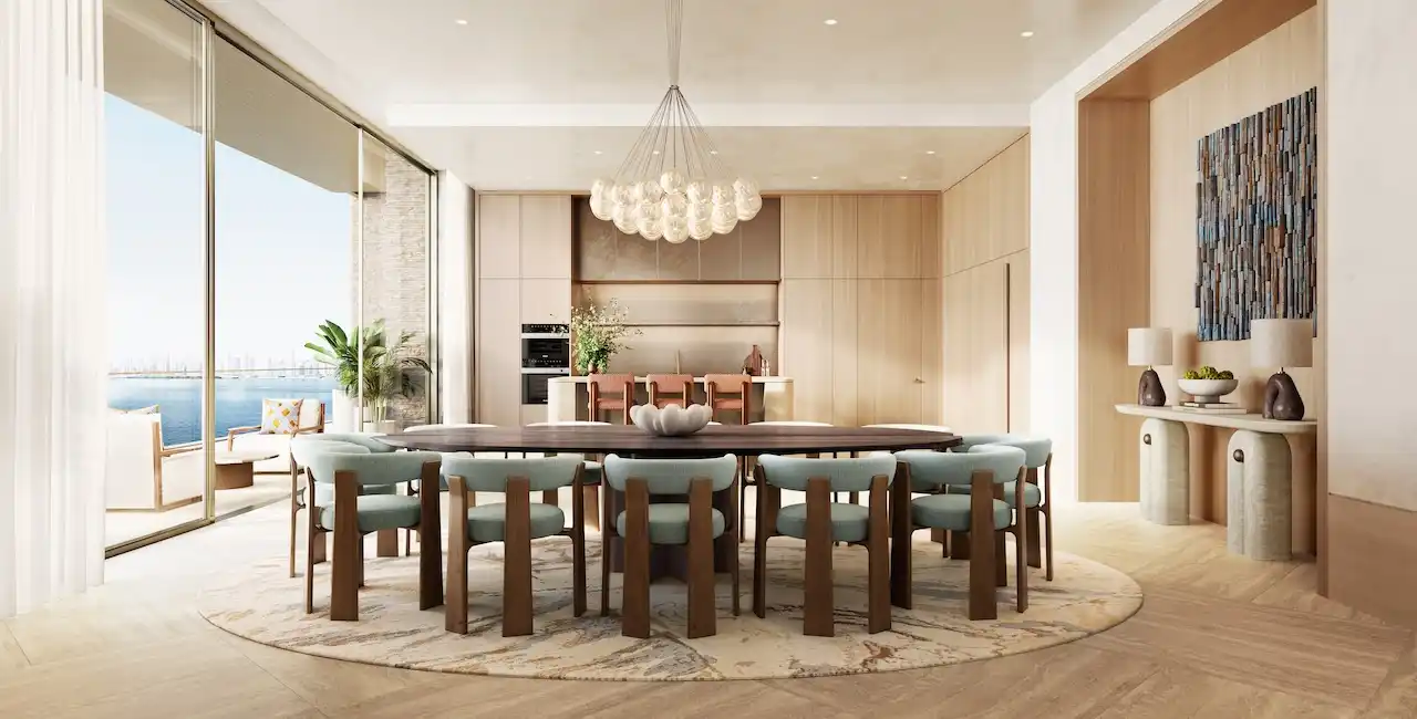Kitchen and dining area of a 5 bedroom apartment at Solaya by Meraas in Dubai, featuring a spacious dining table, open plan kitchen, floor to ceiling windows, Gulf views and refined contemporary finishes. Presented by Tohid Fetrat.