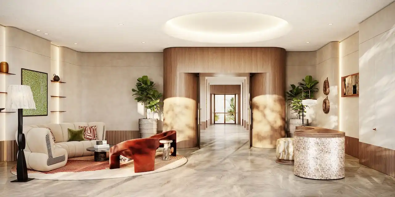 Luxury arrival lobby interior at Solaya by Meraas in Dubai, featuring a refined lounge seating area, warm natural materials, sculptural design elements and a calm welcoming atmosphere. Presented by Tohid Fetrat.