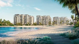 Beachfront exterior view of Solaya by Meraas in Dubai, showcasing elegant low rise residential buildings along a private sandy beach with lush landscaping and serene coastal surroundings. Presented by Tohid Fetrat.