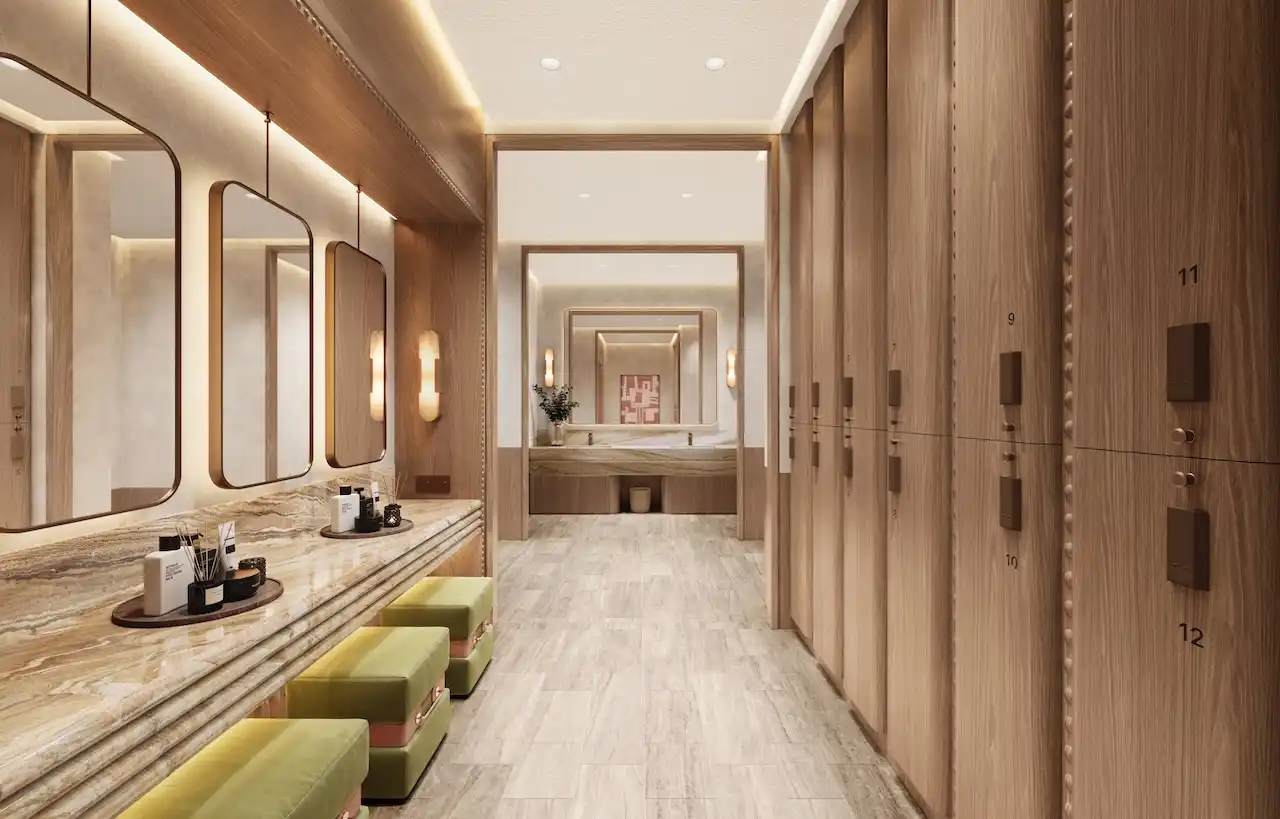 Luxury gym changing room interior at Solaya by Meraas in Dubai, featuring elegant wood finishes, private lockers, vanity counters and a refined wellness focused design. Presented by Tohid Fetrat.