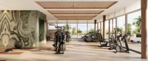 Luxury gym interior at Solaya by Meraas in Dubai, featuring modern fitness equipment, natural light, premium finishes and a wellness focused design. Presented by Tohid Fetrat.