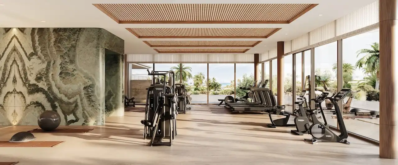 Luxury gym interior at Solaya by Meraas in Dubai, featuring modern fitness equipment, natural light, premium finishes and a wellness focused design. Presented by Tohid Fetrat.