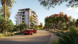 Landscaped access road view of Solaya by Meraas in Dubai, featuring low rise residential buildings surrounded by lush greenery, palm trees and a tranquil resort style environment. Presented by Tohid Fetrat.
