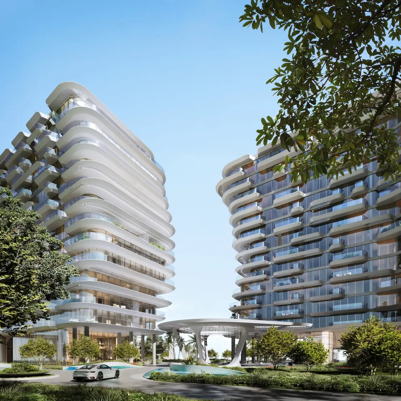 Arrival and drop off area at Arival Piazza Passo by Beyond featuring two sculptural residential towers, curved glass façades, landscaped greenery, and a covered architectural canopy designed for a refined residential entrance experience. Presented by Tohid Fetrat.