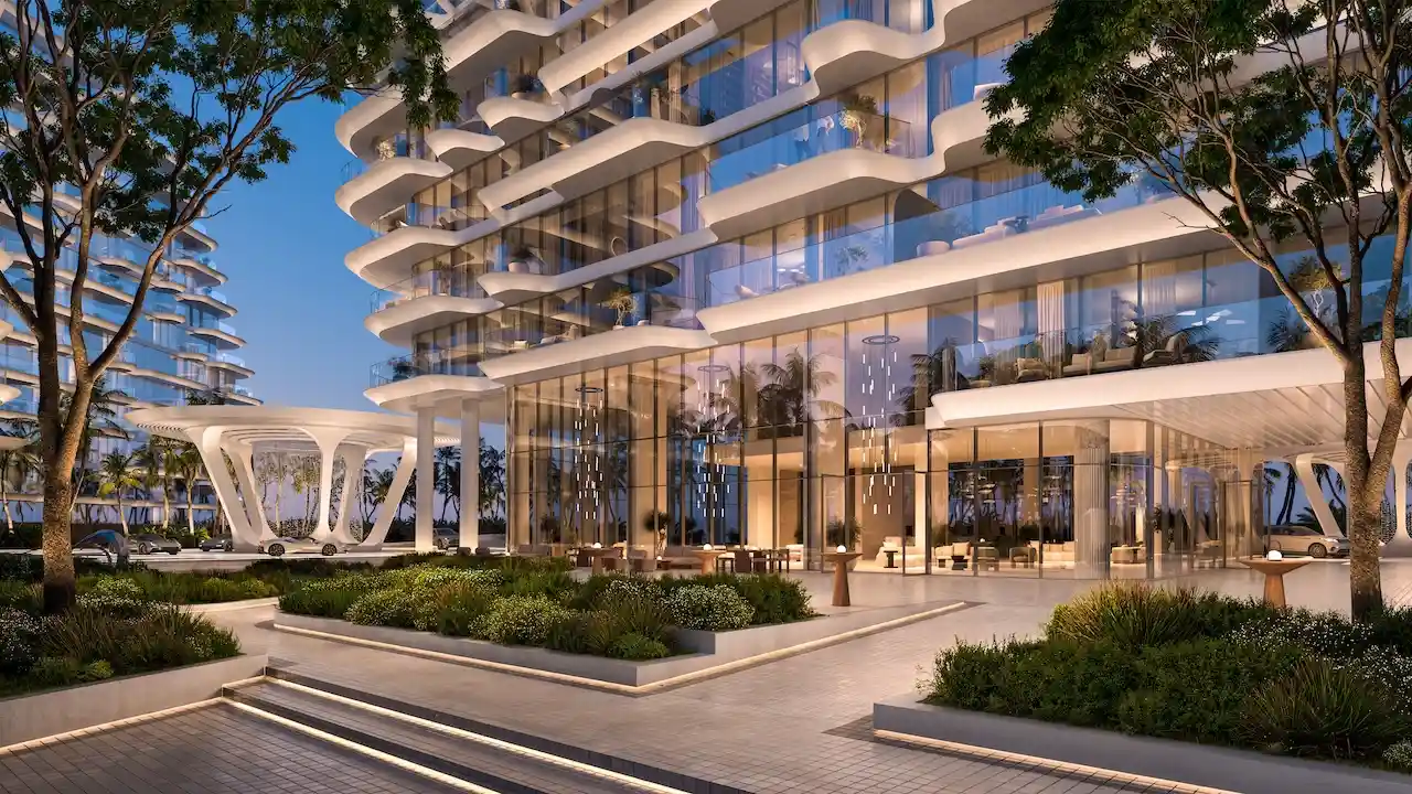 Glass lobby arrival pavilion at Arival Piazza Passo by Beyond featuring floor to ceiling glazing, double height entrance volumes, landscaped forecourt, sculptural canopy structure, and flowing residential balconies defining a refined arrival experience. Presented by Tohid Fetrat.
