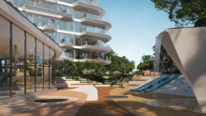 Kids pavilion at Arival Piazza Passo by Beyond featuring a dedicated outdoor play area with sculptural water feature, slide element, soft surface pathways, surrounding greenery, and adjacent residential façades designed for family friendly outdoor activity. Presented by Tohid Fetrat.