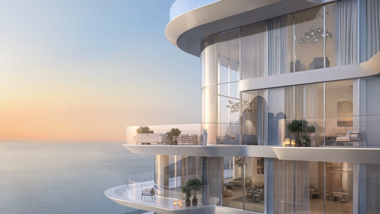 Penthouse exterior at Arival Piazza Passo by Beyond showcasing curved glass façades, expansive wraparound balconies, refined outdoor seating, and uninterrupted sea views that define elevated waterfront living. Presented by Tohid Fetrat.