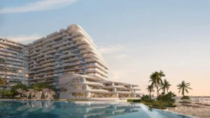 Pool hero view at Arival Piazza Passo by Beyond featuring expansive waterfront swimming pool, sculptural curved architecture, palm lined beachfront, shaded loungers, and seamless connection between resort style amenities and the sea. Presented by Tohid Fetrat.