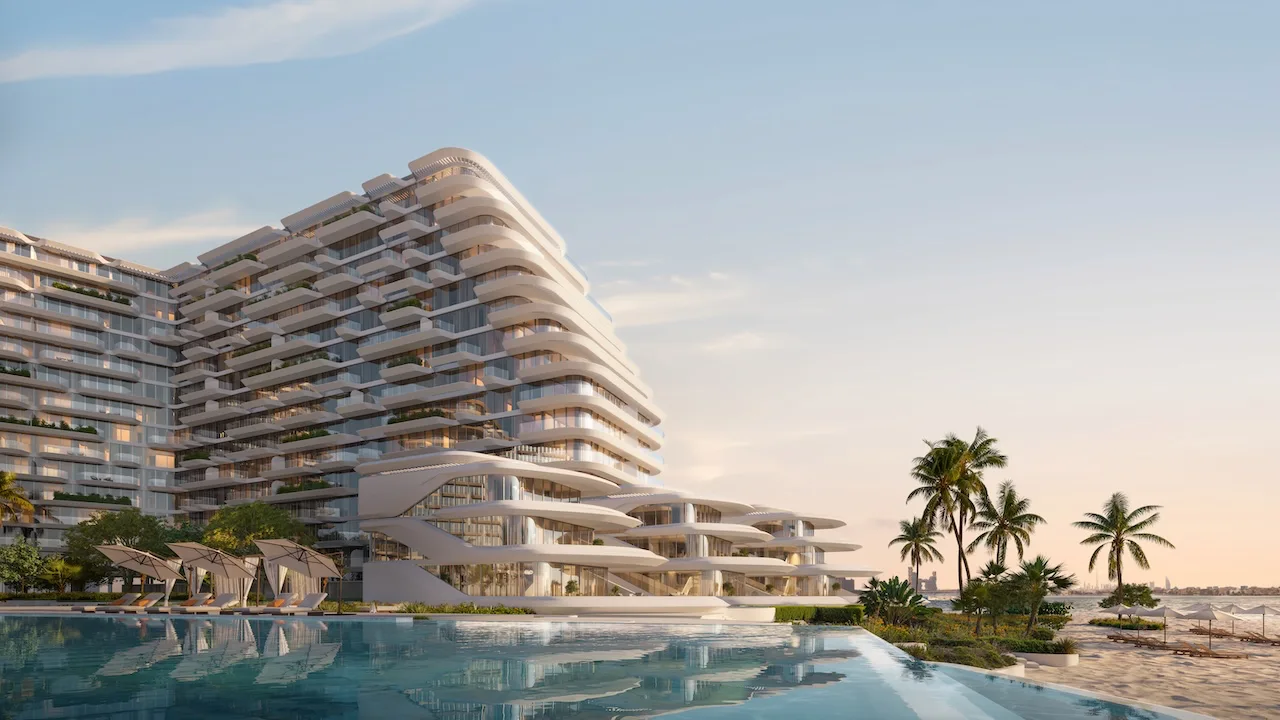 Pool hero view at Arival Piazza Passo by Beyond featuring expansive waterfront swimming pool, sculptural curved architecture, palm lined beachfront, shaded loungers, and seamless connection between resort style amenities and the sea. Presented by Tohid Fetrat.