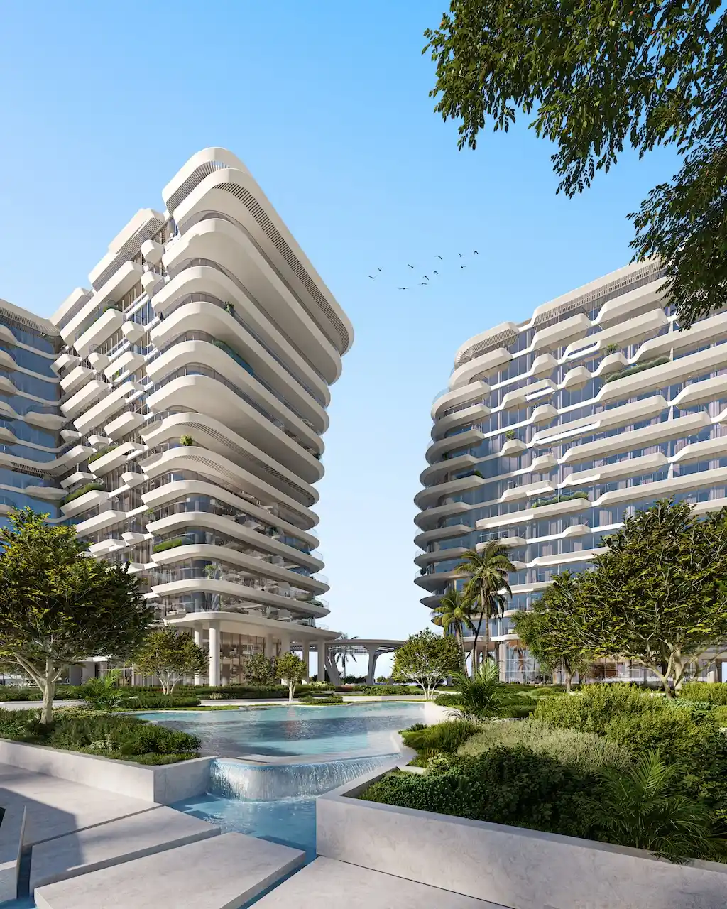 Central water feature and landscaped garden at Arival Piazza Passo by Beyond, showcasing sculptural curved residential towers, cascading water elements, lush greenery, and contemporary resort style architecture in Dubai. Presented by Tohid Fetrat.
