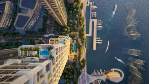 Aerial top-down view of Atelis at d3 showcasing a waterfront residential tower with rooftop pools, landscaped terraces, marina berths, and pedestrian promenades along the water in Dubai Design District. Presented by Tohid Fetrat.