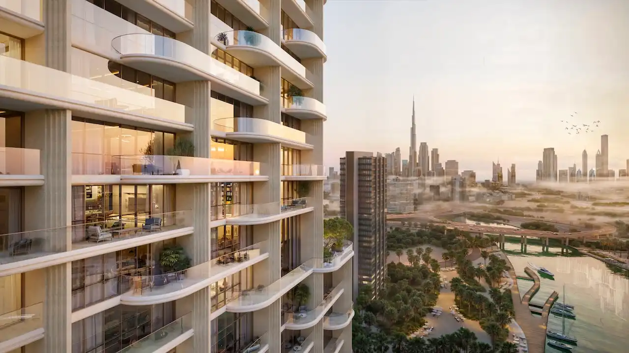 Balcony residences at Atelis at d3 featuring curved glass façades, private terraces, and panoramic views toward Burj Khalifa and Dubai skyline in Dubai Design District. Presented by Tohid Fetrat.