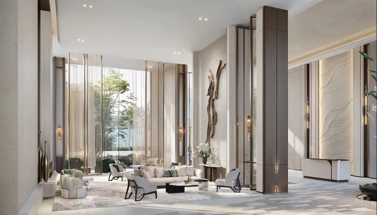 Luxury lobby interior at Atelis at d3 featuring double-height ceilings, elegant lounge seating, sculptural wall art, and refined modern finishes in Dubai Design District. Presented by Tohid Fetrat.
