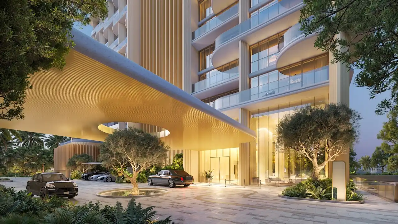 Main entrance and drop-off area of Atelis at d3 featuring sculptural canopy design, landscaped greenery, and contemporary residential architecture in Dubai Design District. Presented by Tohid Fetrat.