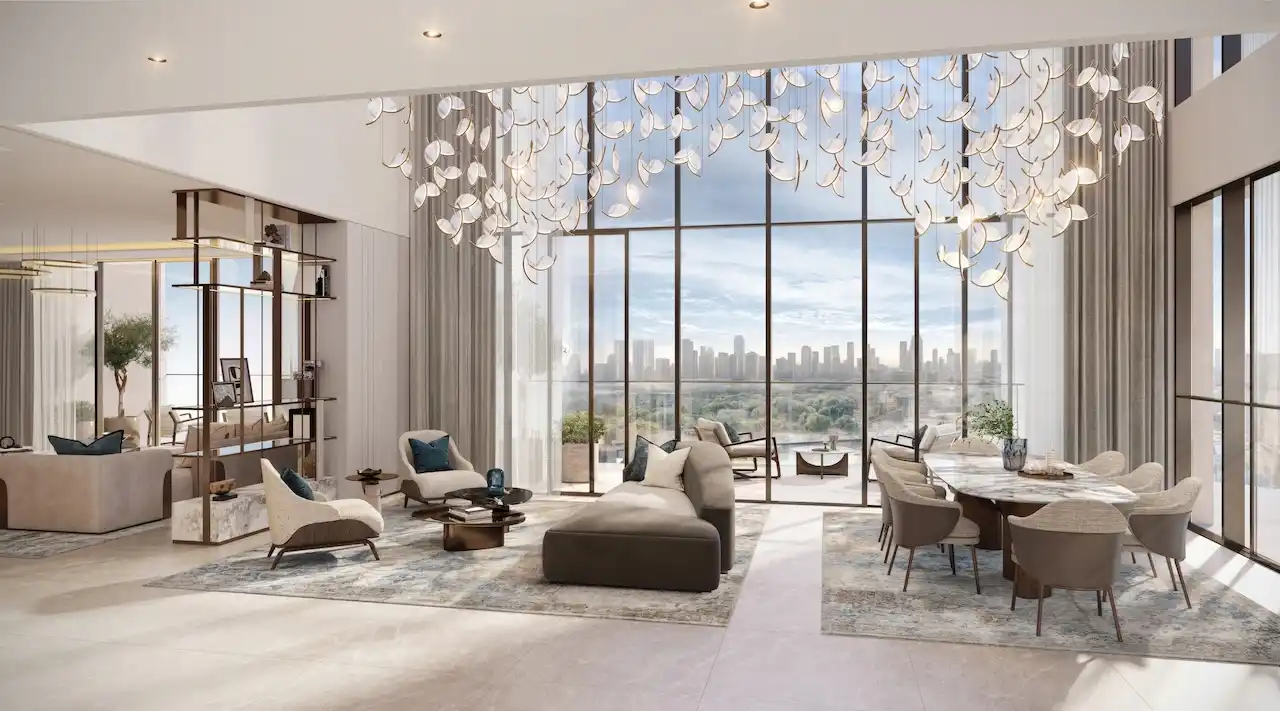 Penthouse dining and living interior at Atelis at d3 featuring double-height ceilings, floor-to-ceiling windows, bespoke chandelier lighting, and panoramic skyline views in Dubai Design District. Presented by Tohid Fetrat.