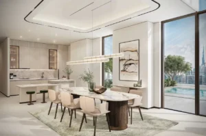 Sky villa dining area at Atelis at d3 featuring an open-plan kitchen, marble dining table, contemporary lighting, and floor-to-ceiling glass with terrace and skyline views in Dubai Design District. Presented by Tohid Fetrat.