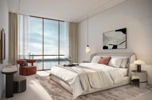 Modern bedroom in a typical residence at Atelis at d3 featuring floor-to-ceiling windows, refined interior finishes, soft neutral tones, and a serene waterfront outlook in Dubai Design District. Presented by Tohid Fetrat.