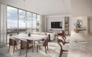 Open-plan dining and living area in a typical residence at Atelis at d3, featuring floor-to-ceiling windows, refined modern interiors, natural light, and elegant finishes overlooking Dubai Design District. Presented by Tohid Fetrat.