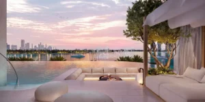 Waterfront lounge at Atelis at d3 featuring an infinity-edge pool, private cabana seating, and serene sunset views over Dubai Creek in Dubai Design District. Presented by Tohid Fetrat.