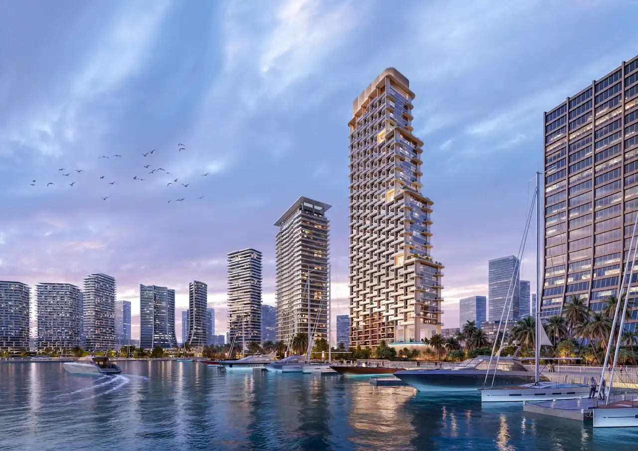 Waterfront residential towers of Atelis at d3 overlooking the marina, featuring contemporary architecture, yachts, and a vibrant urban skyline in Dubai Design District. Presented by Tohid Fetrat.