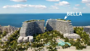 Aerial daytime beachfront view of Bella at Passo by Beyond on Palm Jumeirah showcasing stepped contemporary buildings, landscaped gardens, resort style swimming pools, and direct beach frontage along Dubai’s coastline. Presented by Tohid Fetrat.