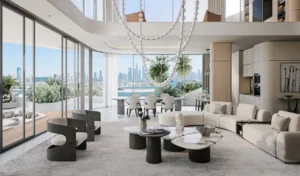 Double-height living and dining area at Bella at Passo by Beyond Beach Mansion with floor-to-ceiling windows, sculptural chandelier, open-plan luxury interiors, and panoramic Dubai skyline views on Palm Jumeirah, Presented by Tohid Fetrat