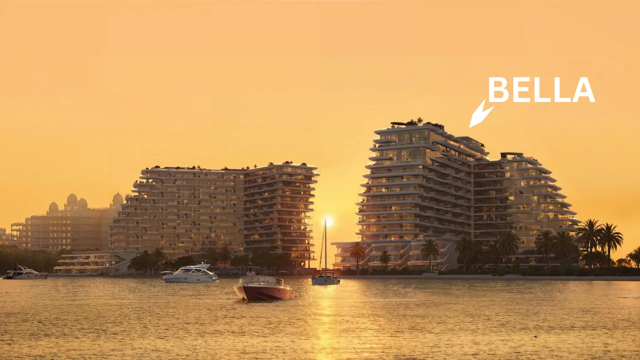 Sunset waterfront view of Bella at Passo by Beyond on Palm Jumeirah featuring stepped contemporary architecture, illuminated façades, palm lined shoreline, anchored boats, and calm coastal waters in Dubai. Presented by Tohid Fetrat.
