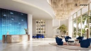 Aqua Lounge at Chelsea Residences by DAMAC, featuring the Chelsea Blue aquarium lounge with elegant seating, a striking blue aquarium wall, and refined interiors designed for a calm luxury lifestyle in Dubai. Presented by Tohid Fetrat.