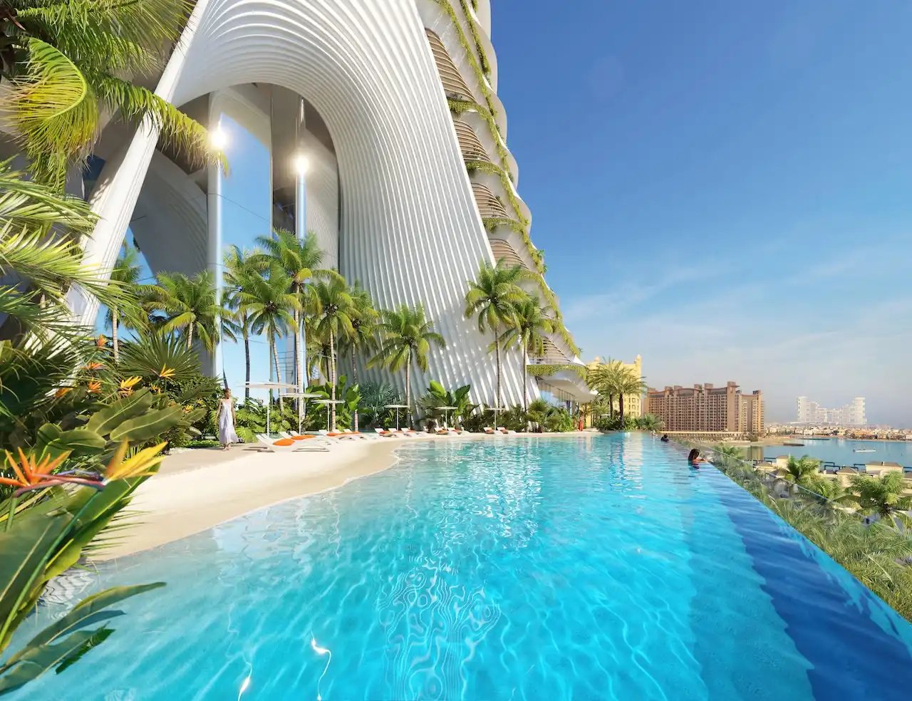 Infinity pool and beach deck at COMO Residences on Palm Jumeirah, featuring sculptural tower columns, lush tropical landscaping, elevated resort amenities, and panoramic views of the Gulf. Presented by Tohid Fetrat.