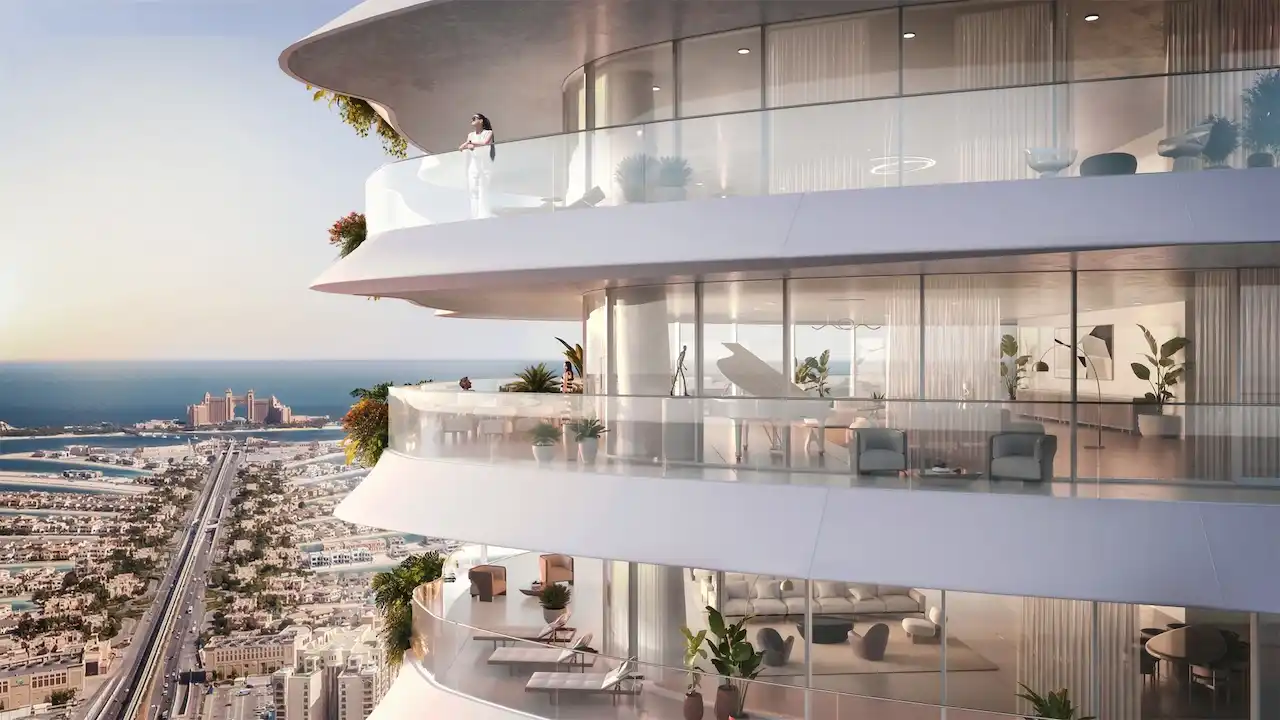 Curved balcony exterior at COMO Residences featuring private terraces, transparent glass balustrades, floor to ceiling glazing, refined interior furnishings, and panoramic sea views overlooking Palm Jumeirah in Dubai. Presented by Tohid Fetrat.
