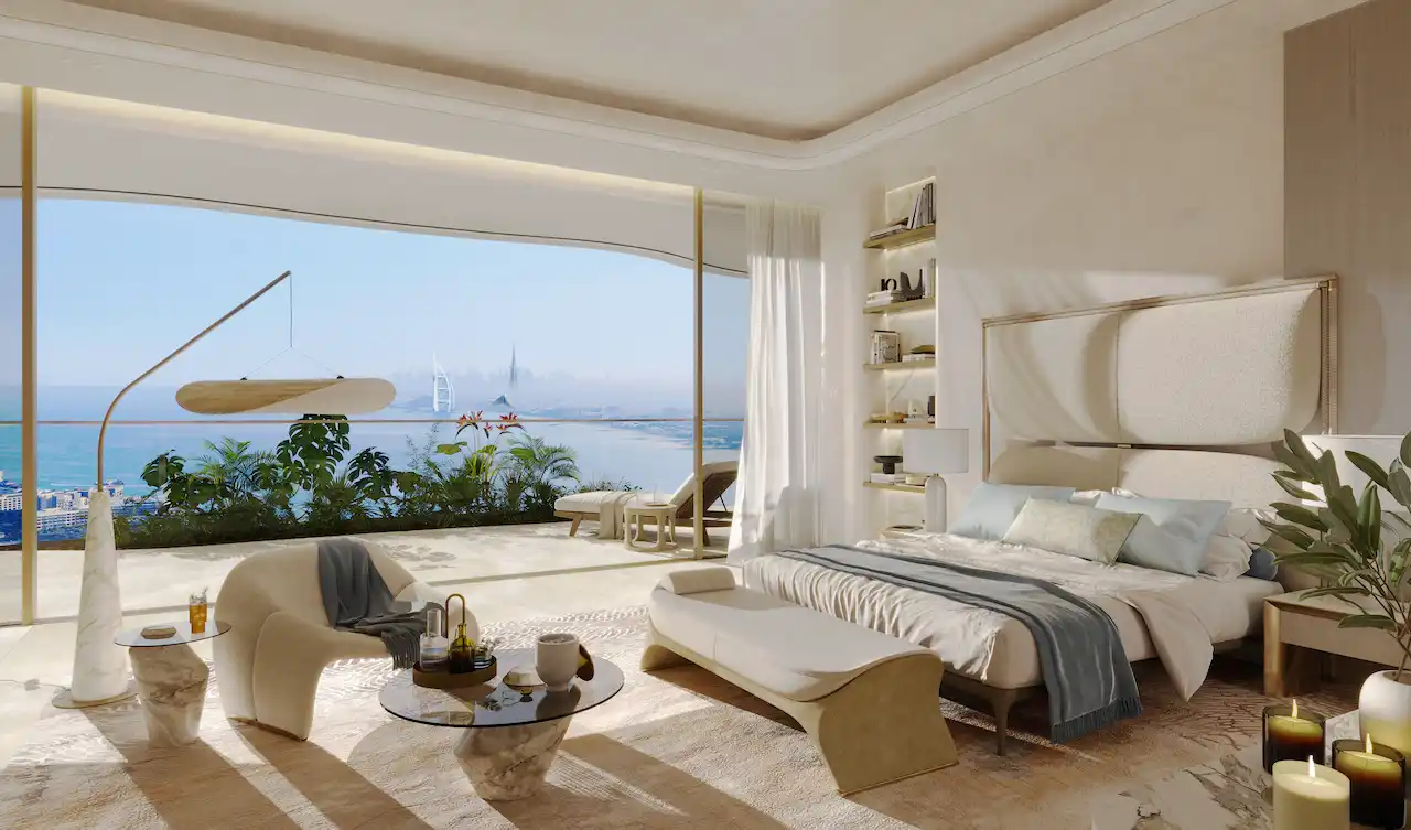 Luxury bedroom at COMO Residences on Palm Jumeirah during the day featuring soft natural light, elegant furnishings, floor-to-ceiling glass, and panoramic Gulf and Dubai skyline views. Presented by Tohid Fetrat.