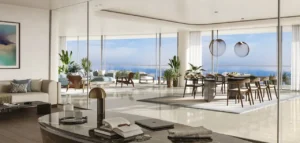 Elegant luxury home office and open living-dining space at COMO Residences on Palm Jumeirah, featuring floor-to-ceiling glass, refined contemporary furniture, and panoramic Gulf views. Presented by Tohid Fetrat.