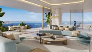 Luxury living area at COMO Residences on Palm Jumeirah featuring bespoke designer sofas, open-plan layout, floor-to-ceiling windows, and panoramic Gulf and Dubai skyline views in daylight. Presented by Tohid Fetrat.