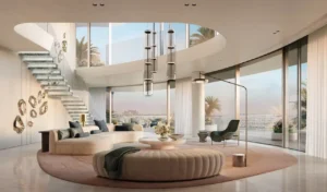 Double-height ultra-luxury living room at COMO Residences on Palm Jumeirah featuring a sculptural floating staircase, statement pendant lighting, bespoke seating, and floor-to-ceiling curved glass with panoramic Gulf views. Presented by Tohid Fetrat.