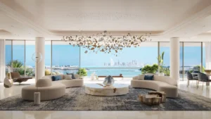 Ultra-luxury living area at COMO Residences on Palm Jumeirah featuring sculptural designer furniture, bespoke chandelier installation, open-plan layout, and panoramic Gulf and Dubai skyline views through floor-to-ceiling windows. Presented by Tohid Fetrat.