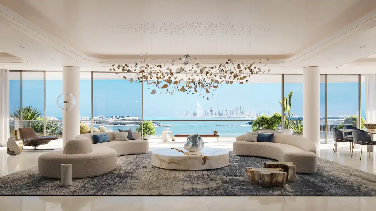Ultra-luxury living area at COMO Residences on Palm Jumeirah featuring sculptural designer furniture, bespoke chandelier installation, open-plan layout, and panoramic Gulf and Dubai skyline views through floor-to-ceiling windows. Presented by Tohid Fetrat.